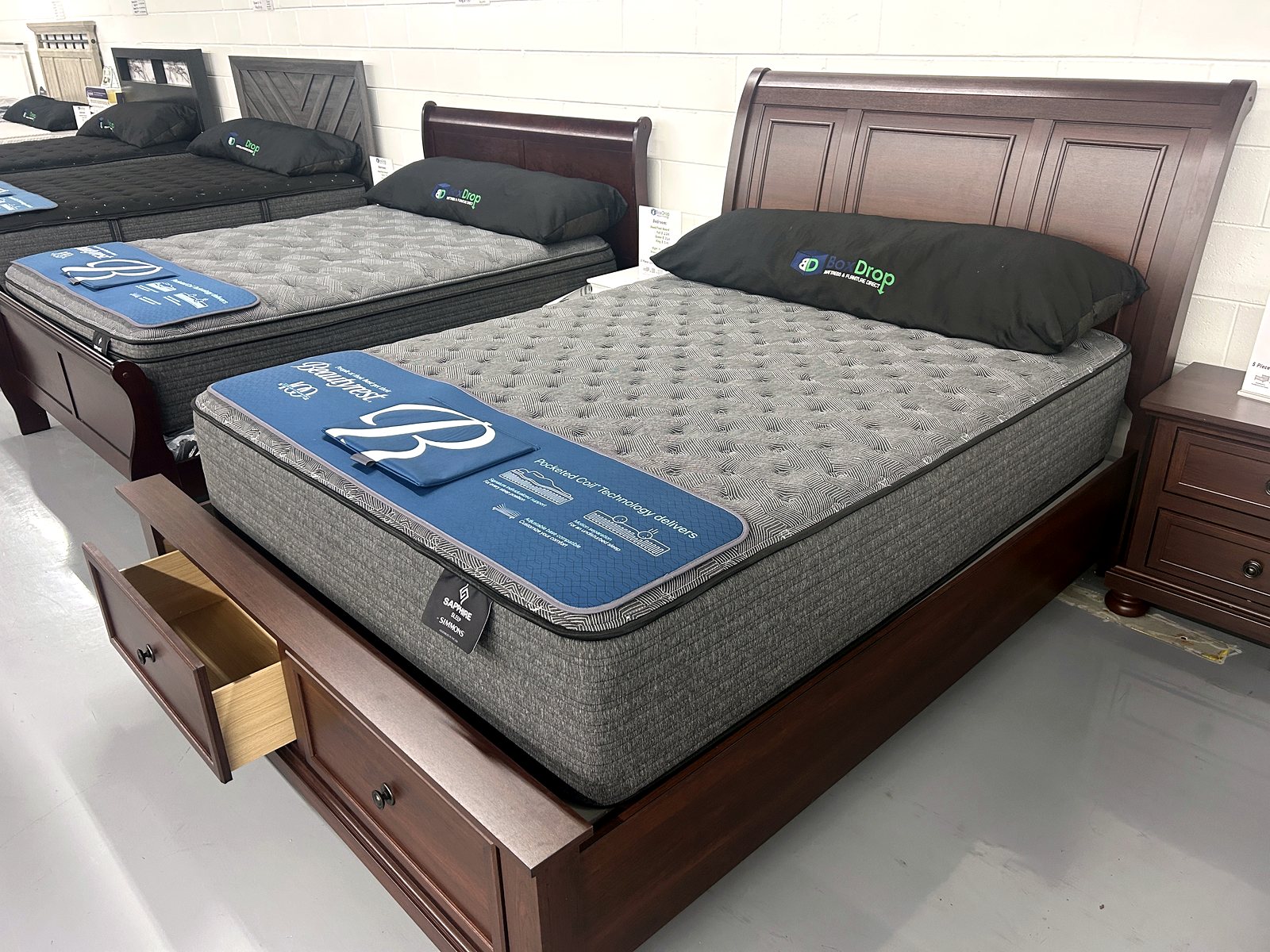 Bed with mattress and wood headboard in the bedroom section