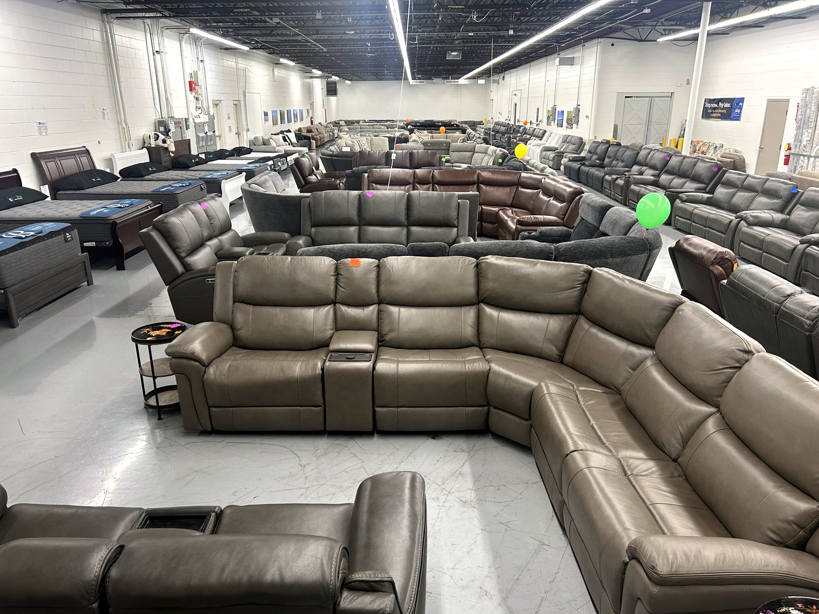 New leather reclining sectionals on the floor