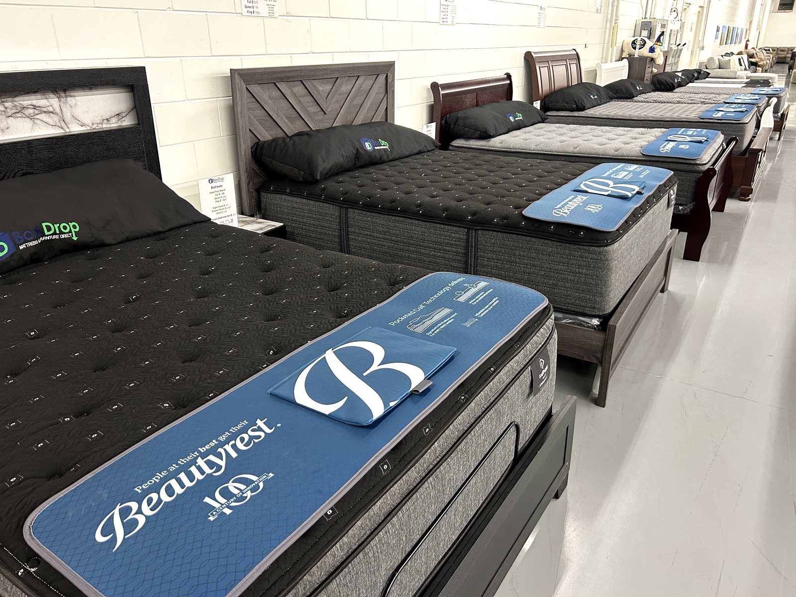 Row of name-brand mattresses on display